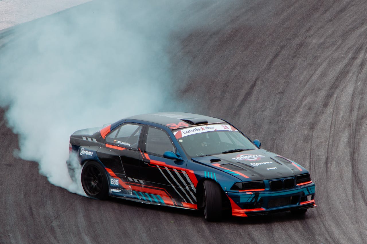 Dynamic drift race car in action on a racing track in Lithuania.